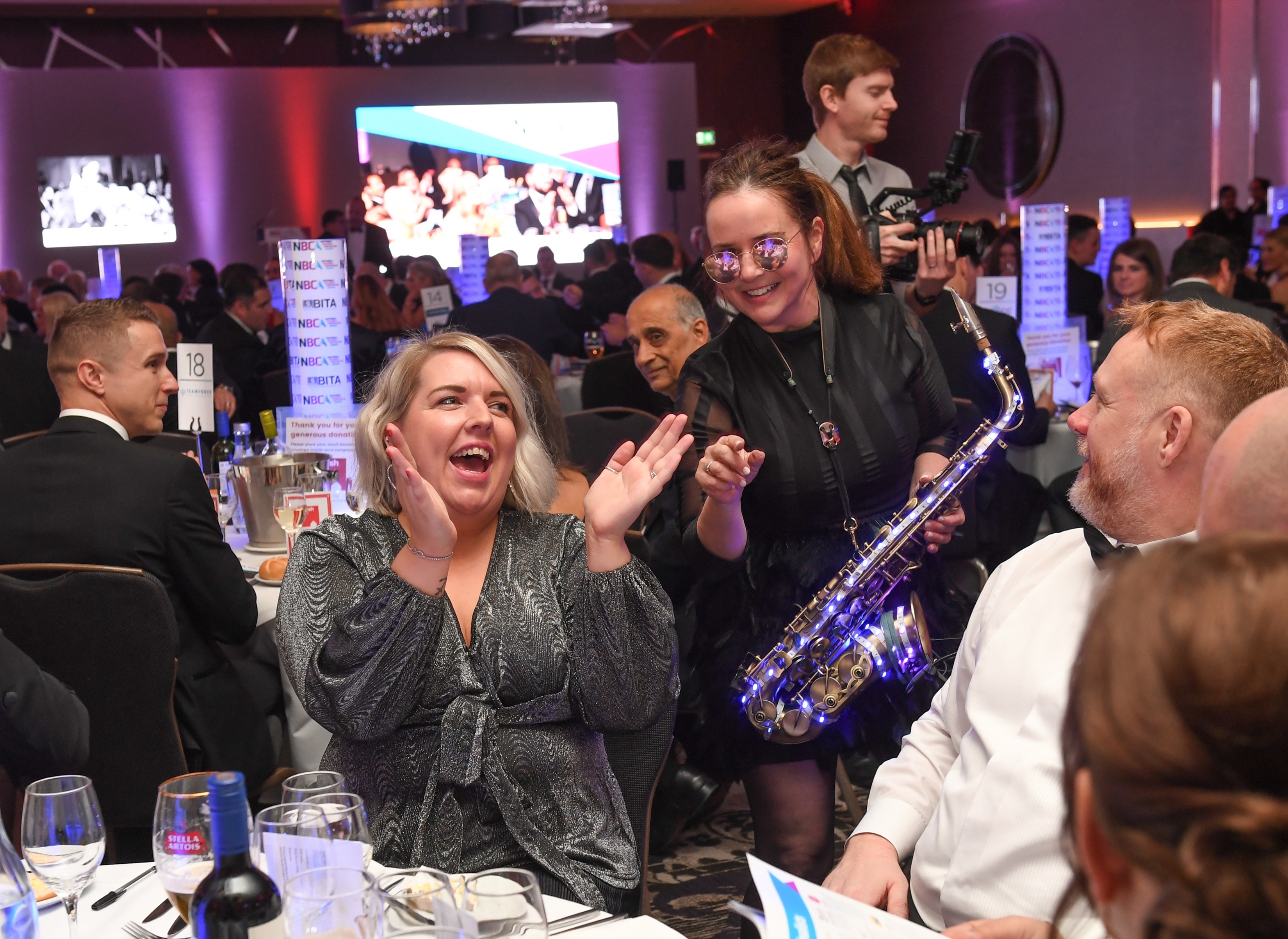 Guests at a table enjoying the entertainment